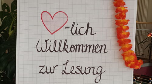 Flipchart. Text: Herzlich willkommen zur Lesung "Careleaving-Storys"